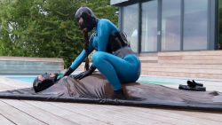 Poolside Vacbed Torment: Blue Latex Domme in Total Control
